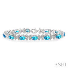 7X5 MM Oval Cut Blue Topaz and 1/10 Ctw Round Cut Diamond Semi-Precious Bracelet in Sterling Silver